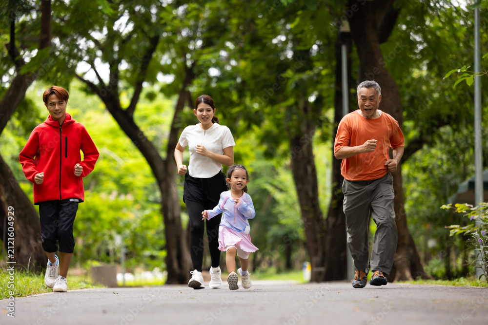 Obraz premium Family exercising and jogging together in city park summer. healthy lifestyle in nature. Father mother, kids daughter exercise. Family team, healthy children. healthy lifestyle and family bonding