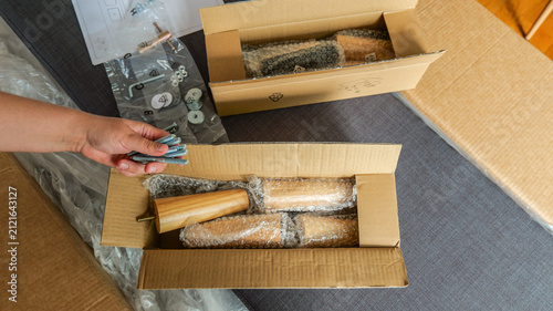 Fotografie Assembling furniture with wooden legs and hardware, ready for DIY project