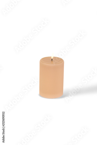 Konstfotografi A single tall light orange wax candle standing upright with a small brown wick a