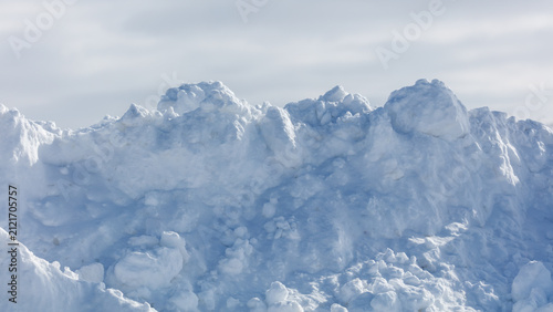 Fotografie Snowy mound rises under pale sky