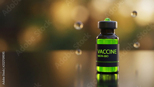 Vaccine vial with a black label stands upright on a dark surface while small translucent droplets float in the air nearby.