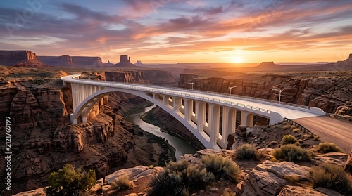 White arch bridge in desert canyon at sunset. Modern infrastructure over river landscape.