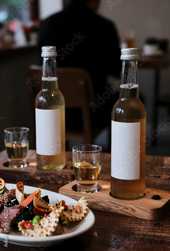 Two clear glass bottles wit...