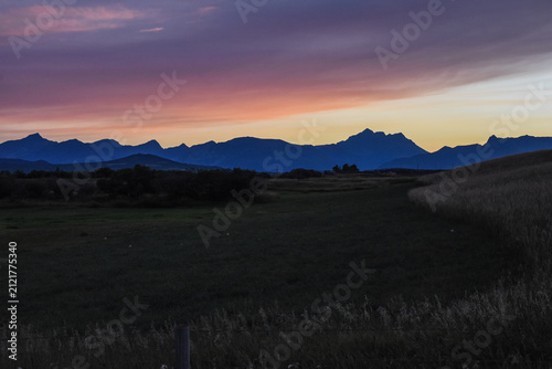 Stunning red sunrise with colourful sky over the open field. Artistic mountain skyline nature.