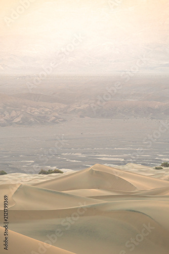 Sweeping sand dunes and hazy Valley in Death Valley desert
