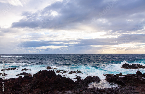 Dramatic coastal landscape at Ponta da Ferraria on Sao Miguel Island, Azores, Portugal, featuring volcanic shoreline, Atlantic Ocean and evening clouds