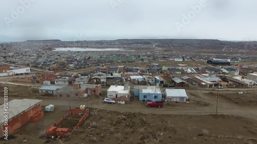 Cinematic 4K drone aerial of new residential neighborhoods in Caleta Olivia, Santa Cruz, Patagonia, Argentina. Showcasing urban growth, modern housing, city planning, infrastructure, and suburban deve