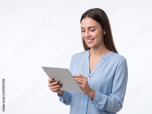 Beautiful smiling woman holding a tablet computer