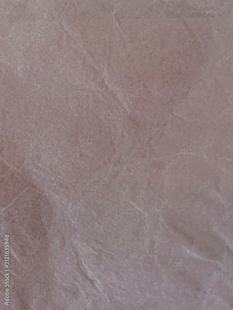 Fototapeta premium Crumpled light pink paper texture background surface close up