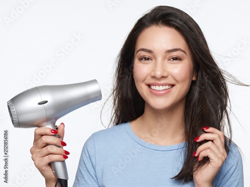 Woman Styling Hair with Hair Dryer 