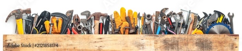 Group of worn work tools. Collection of used blue collar work equipment covered with old board. For home improvement, diy repair projects, Father's day gift ideas, or to celebrate Labor Day.