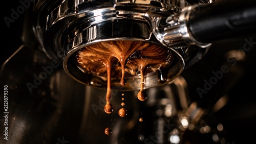 Close-up of professional espresso machine pouring rich coffee into a cup.