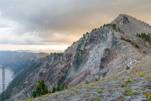 Misty rocky hillside on Crater Lake Rim in the sunset