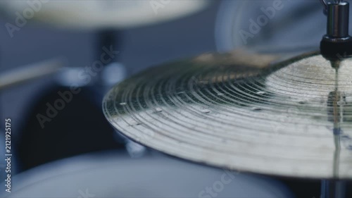 Close up of a cymbal on a drum set capturing metal texture and concentric grooves