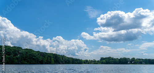 Union Pond in Manchester Connecticut with Scenic Summer Clouds and Tree-Lined Shore