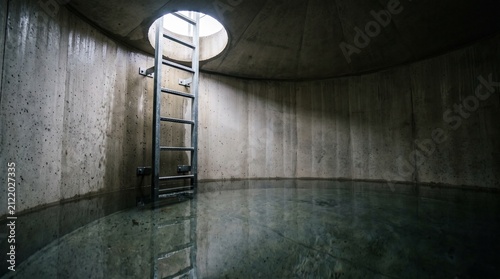 Inside Rainwater Harvesting Tank with Clean Concrete Cistern, Water Reflections and Inspection Ladder | Sustainable Water Storage
