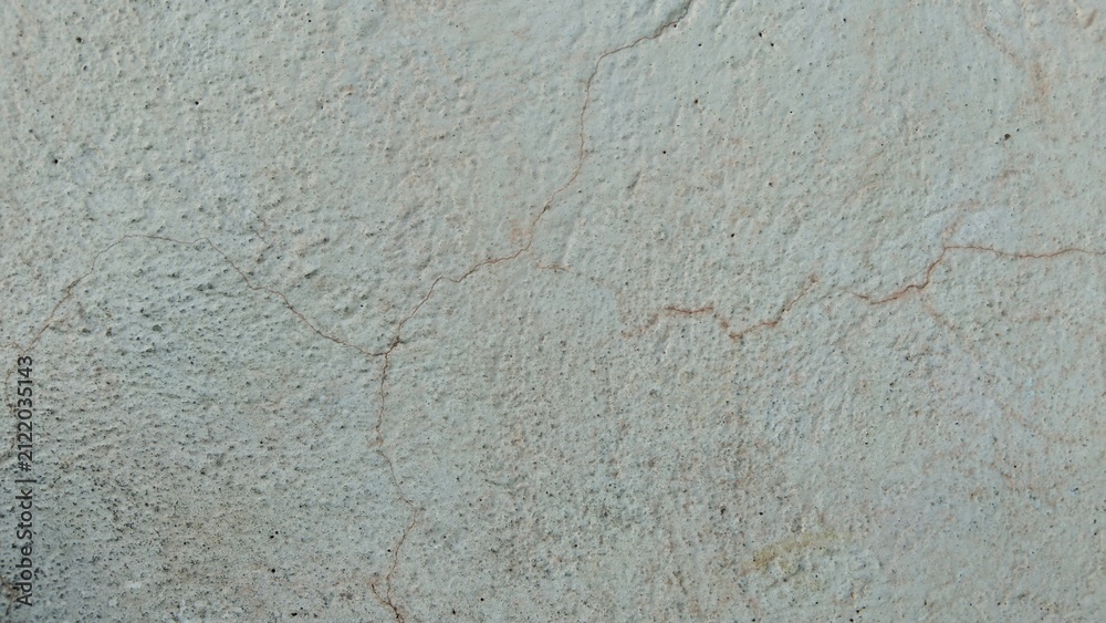 Fototapeta premium Cracked concrete wall surface background texture with rough stucco pattern