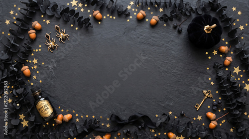 Halloween background with black pumpkins. Festive autumn flat lay with spooky decorations.