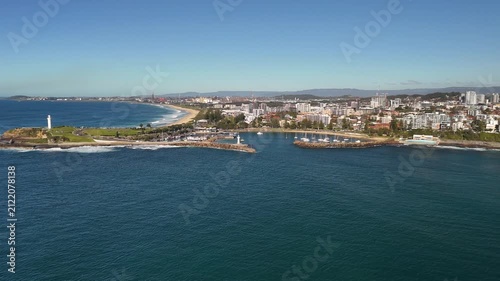 Aerial drone view of Wollongong on the NSW South Coast, Australia looking in the south direction over Belmore Basin and Breakwater Lighthouse on a sunny day in August 2026  