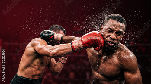 A professional boxing match featuring two athletes exchanging powerful punches in a high-energy, cinematic ring environment