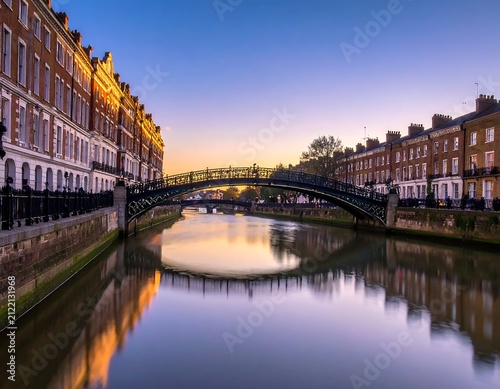 Historic Brick Townhouses Reflecting Along Calm Canal at Sunset