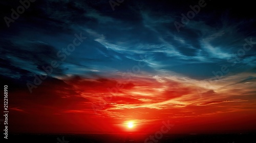 Fiery sunset paints the sky with vibrant red and deep blue hues.