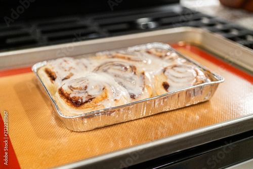 Freshly Baked Cinnamon Rolls Cooling on Stove Top