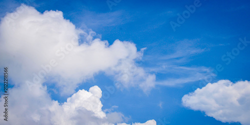 Quadro su tela Bright blue sky with fluffy white cumulus clouds on a clear sunny day, natural sky background with copy space