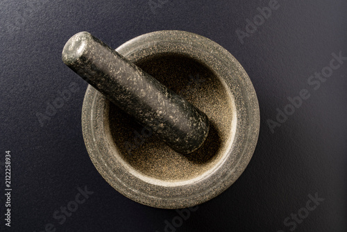 Cuadro en lienzo Granite mortar and pestle top view on black background, closeup