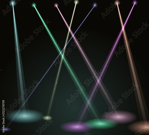 Bright colorful stage spotlights shining upwards in the dark night