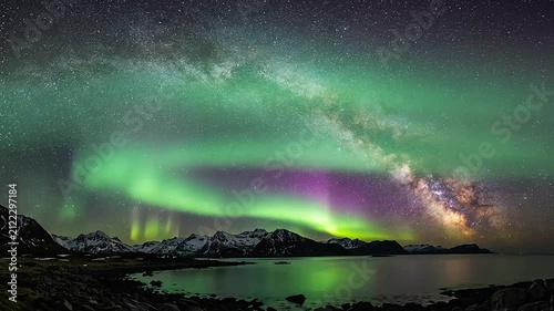 Vibrant aurora borealis lights dance over a dark mountain lake