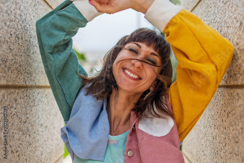 Close-up portrait of attractive joyful girl with amazing smile wears stylish yellow sunglasses and shirt.