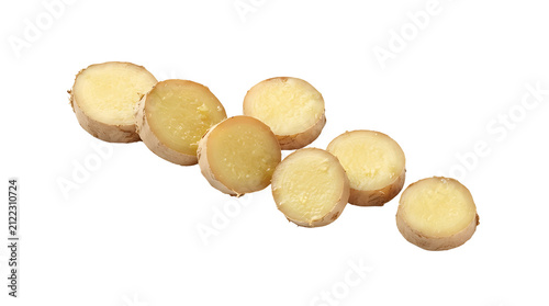 Sliced ginger root pieces arranged on a white background, showing their pale yellow interior and light brown skin.
