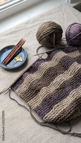 Knitting Project with Wavy Striped Pattern on Linen Fabric