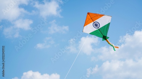 Indian tricolour kite flying high in the blue sky. Saffron white and green kite with Ashoka Chakra for Indian Independence Day celebration