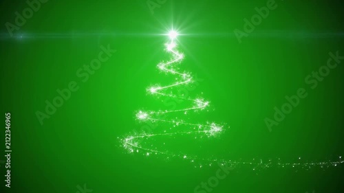 Sparkling light particles forming a Christmas tree on a green background with subtle lens flare