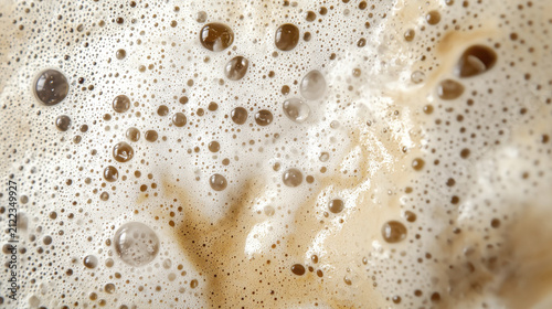 Steaming close up of frothy beverage with bubbles and texture, creating warm and inviting atmosphere