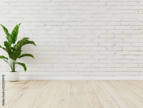 minimalist room with light wooden flooring, a white brick wall, and a single green potted plant on the left side.