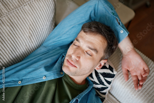 Man Relaxing on Sofa at Home Practicing Mindfulness