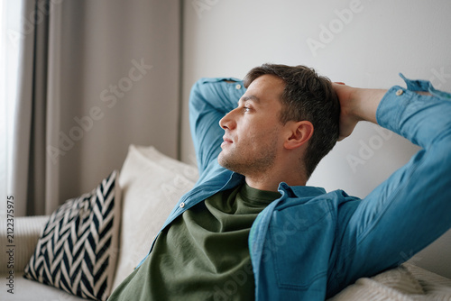 Man Relaxing on Sofa at Home Practicing Mindfulness