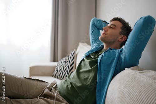 Man Relaxing on Sofa at Home Practicing Mindfulness
