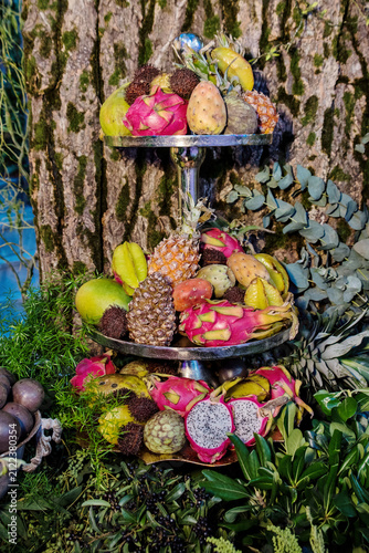 Tiered silver stand with exotic tropical fruits at catering event