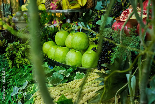 Green apples and pomegranates on a lavishly decorated catering table
