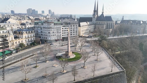 Aerial parallax panning view rotating around historic Golden Lady monument in Constitution Square