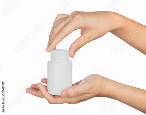 Hand holding blank medicine bottle isolated on white background.