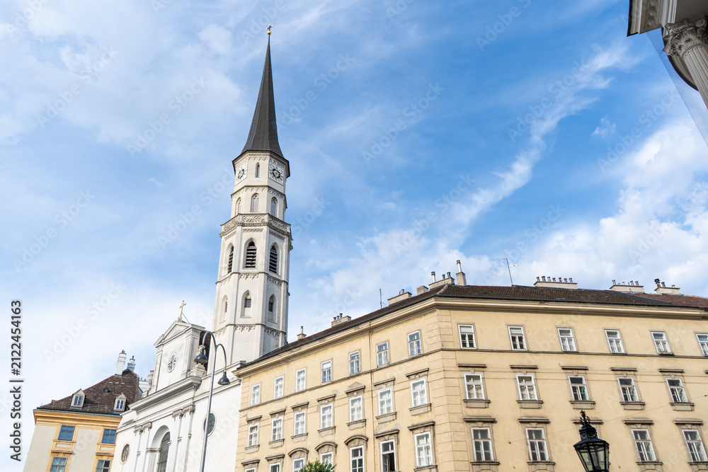 Obraz premium St Michael Church Tower and Historic Facade View at Michaelerplatz Square in Central Vienna Austria