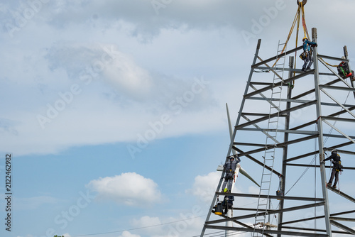 Lineman Electrician working on transmission tower  