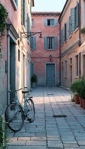 Bicycle leaning against wall on narrow European street with tall plaster buildings