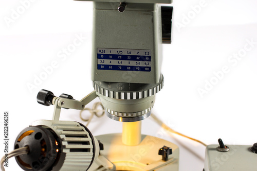 Canvas Print Close-up of a vintage stereo microscope objective with external illuminator and magnification controls
