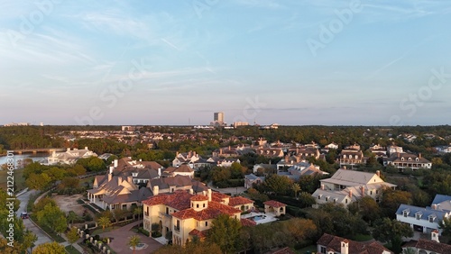Aerial view of luxury houses in Houston, Woodlands by the lake with dramatic cloudy sky in Texas, United States	
